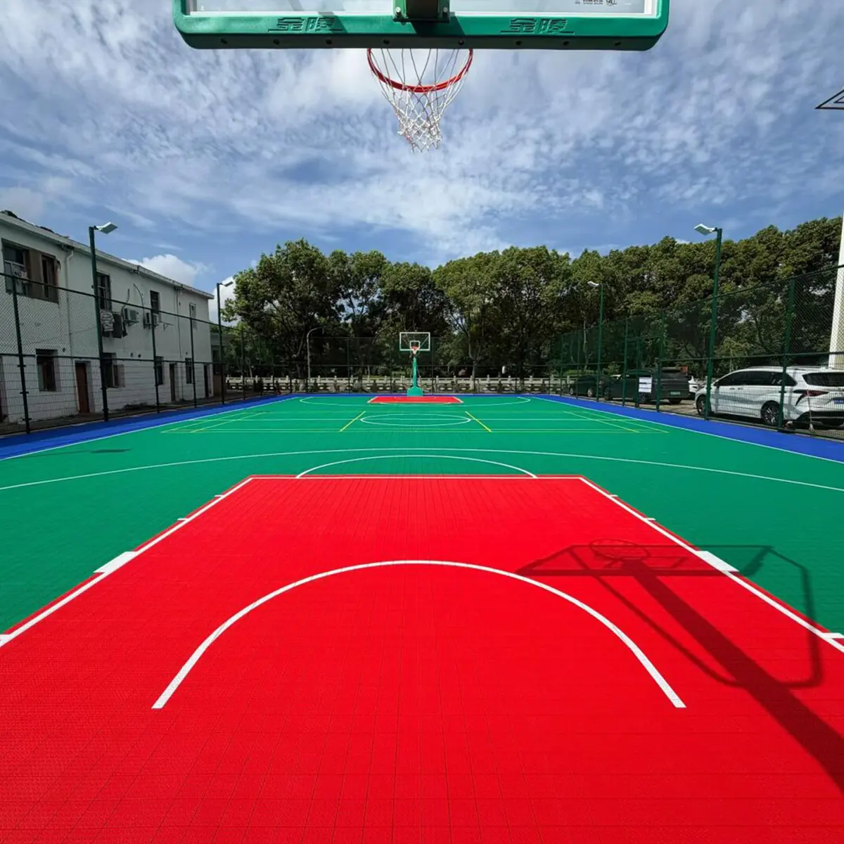Outdoor basketball court installation with color-blocked play areas