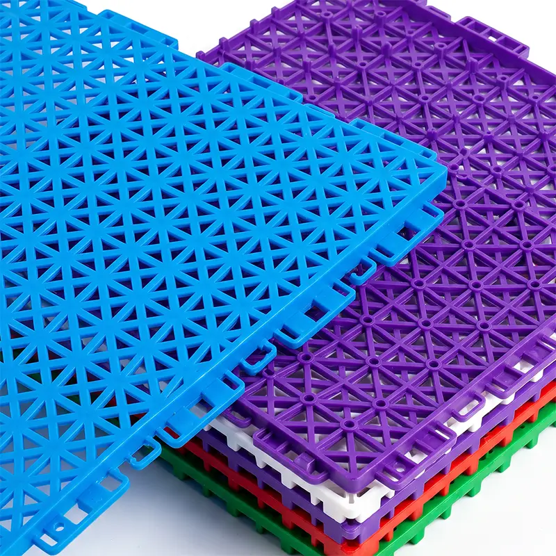 Colorful interlocking modular flooring tiles stacked on a white background